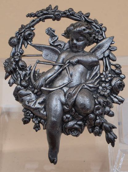 Silvertone Repousse Cupid With A Bow In A Floral Wreath Vintage 2.5" Brooch