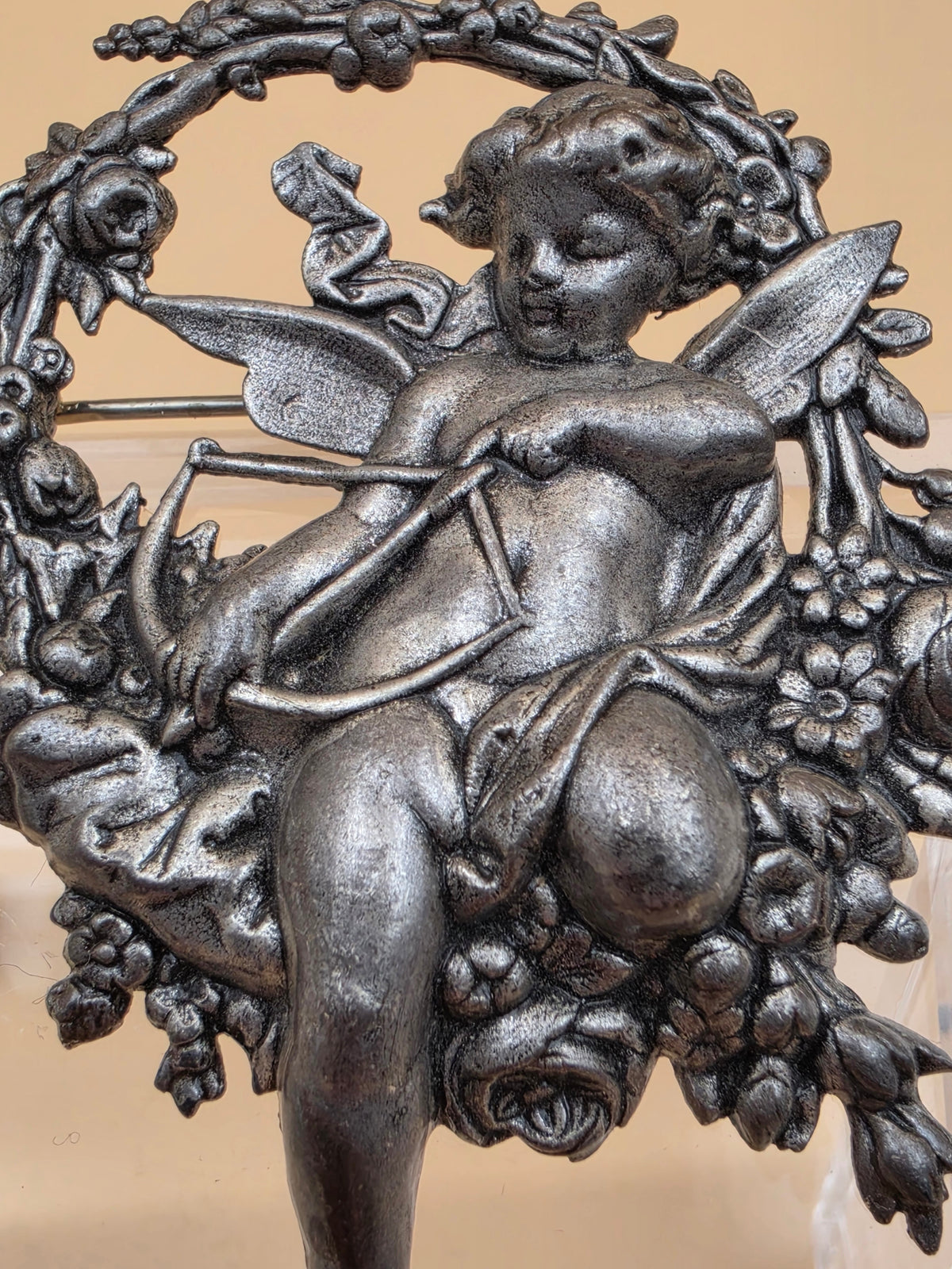 Silvertone Repousse Cupid With A Bow In A Floral Wreath Vintage 2.5" Brooch