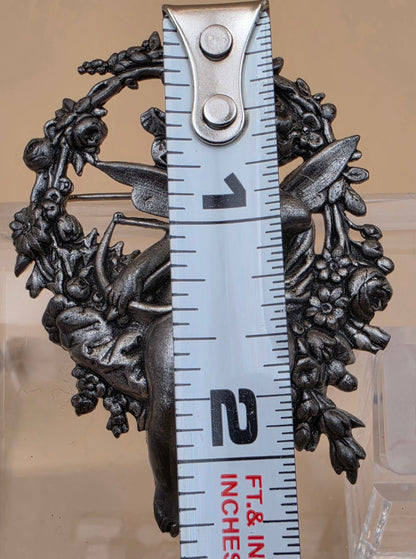 Silvertone Repousse Cupid With A Bow In A Floral Wreath Vintage 2.5" Brooch