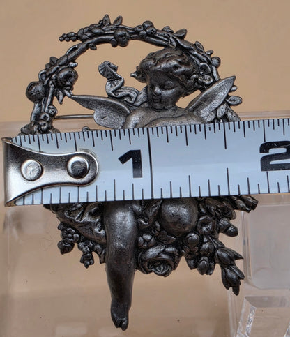 Silvertone Repousse Cupid With A Bow In A Floral Wreath Vintage 2.5" Brooch