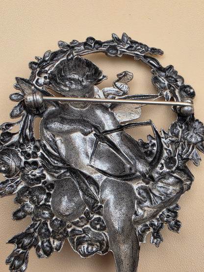 Silvertone Repousse Cupid With A Bow In A Floral Wreath Vintage 2.5" Brooch