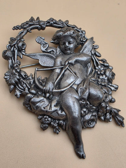 Silvertone Repousse Cupid With A Bow In A Floral Wreath Vintage 2.5" Brooch