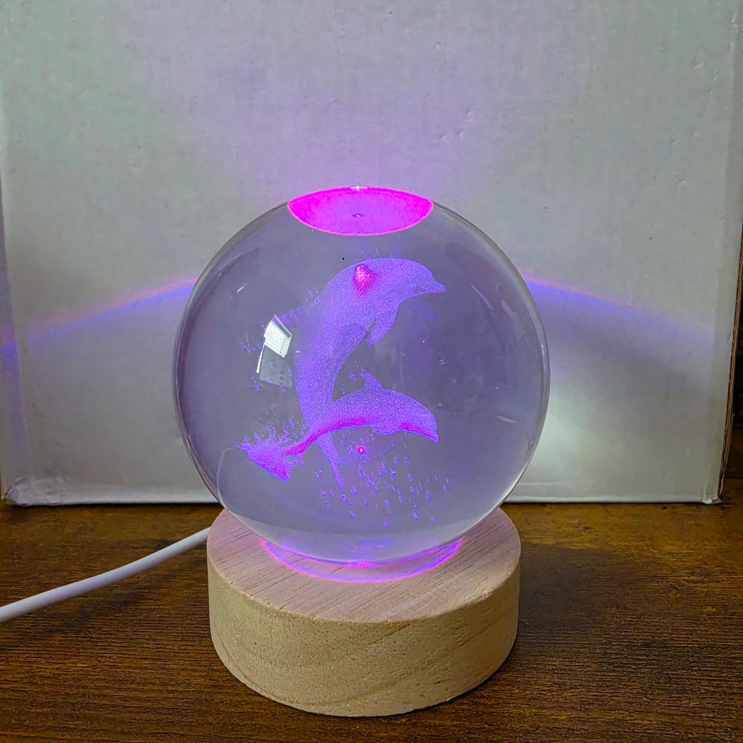 3D Laser Etched Jumping Dolphins Crystal Ball On A Wooden LED Base With Alternating Colors