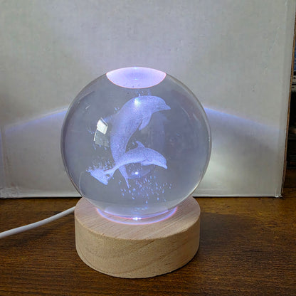 3D Laser Etched Jumping Dolphins Crystal Ball On A Wooden LED Base With Alternating Colors