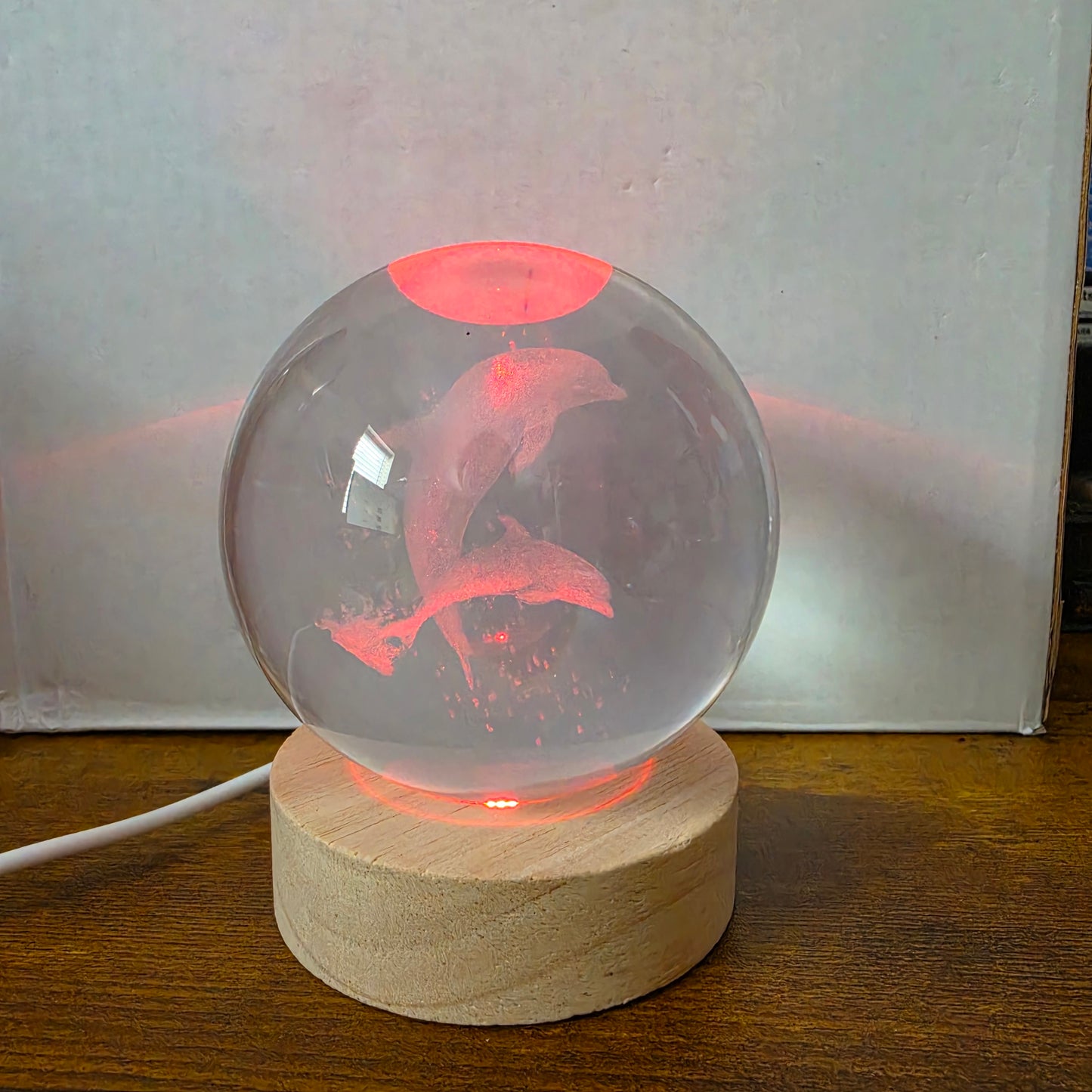 3D Laser Etched Jumping Dolphins Crystal Ball On A Wooden LED Base With Alternating Colors