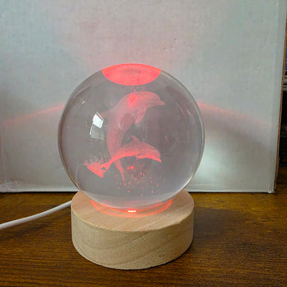 3D Laser Etched Jumping Dolphins Crystal Ball On A Wooden LED Base With Alternating Colors