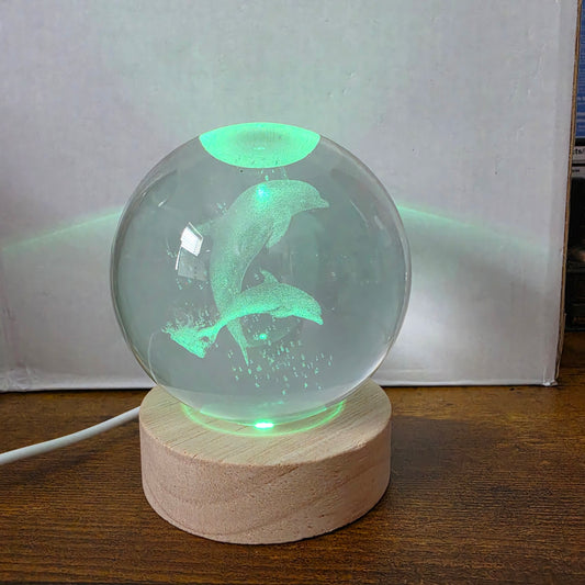 3D Laser Etched Jumping Dolphins Crystal Ball On A Wooden LED Base With Alternating Colors
