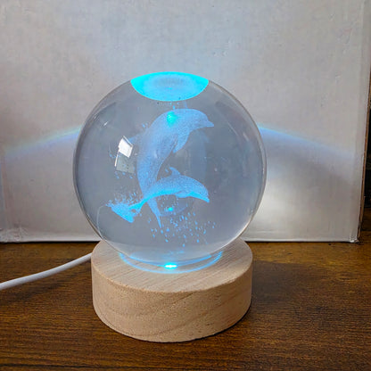 3D Laser Etched Jumping Dolphins Crystal Ball On A Wooden LED Base With Alternating Colors