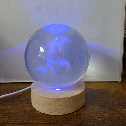 3D Laser Etched Jumping Dolphins Crystal Ball On A Wooden LED Base With Alternating Colors