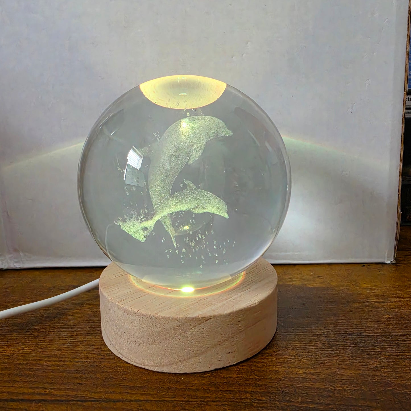 3D Laser Etched Jumping Dolphins Crystal Ball On A Wooden LED Base With Alternating Colors