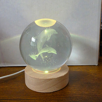 3D Laser Etched Jumping Dolphins Crystal Ball On A Wooden LED Base With Alternating Colors