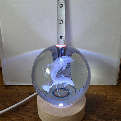 3D Laser Etched Jumping Dolphins Crystal Ball On A Wooden LED Base With Alternating Colors